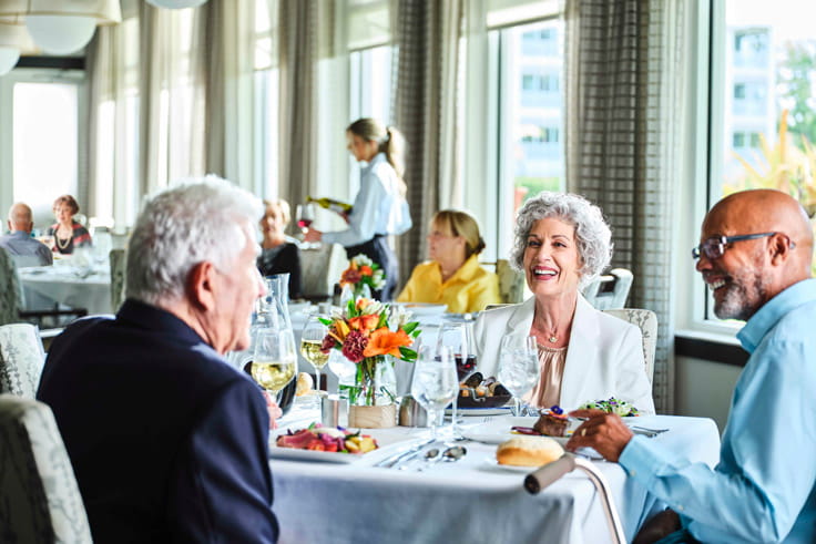 Residents dine together at a community's restaurant.
