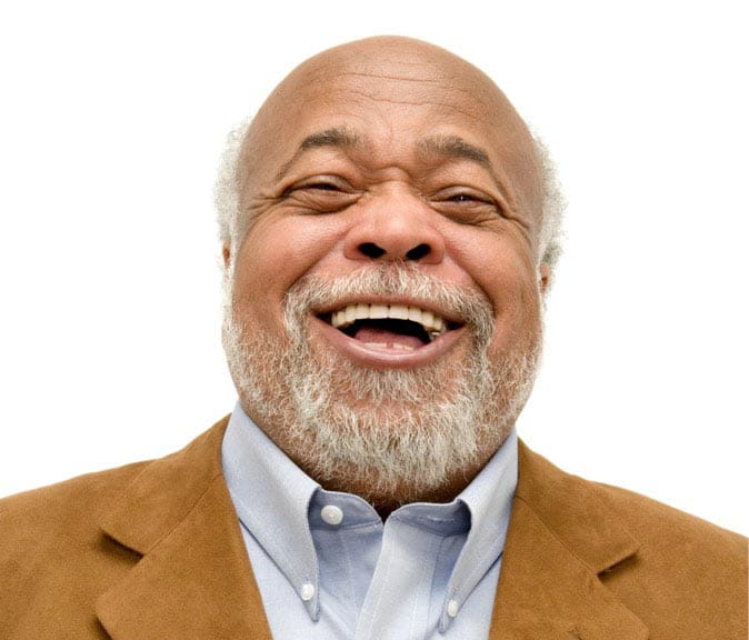 A man smiles as he looks directly into the camera.