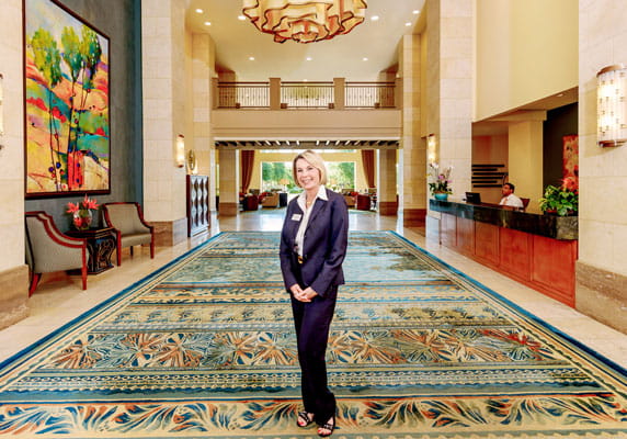 The concierge poses in front of the lobby.