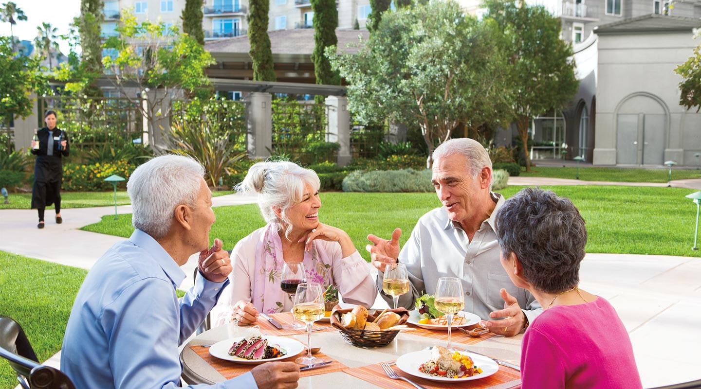 Two couples enjoy a meal al fresco at Vi at La Jolla Village.