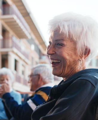 A meditation club member smiles at a fellow resident.